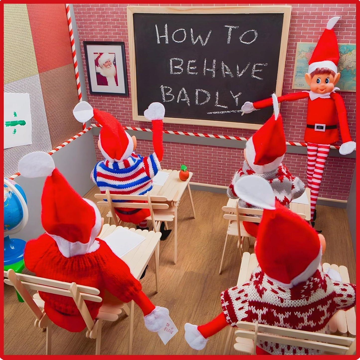 Close up of soft Christmas Elf plush toy showing red hat, smiling face, and plush details